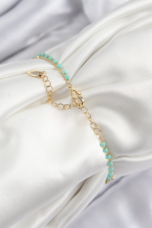 BB7599 - Pirinç Zirkon Taşlı Mavi Boncuklu Model Gold Renk Kadın Bileklik